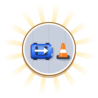 A blue car facing an orange traffic cone.