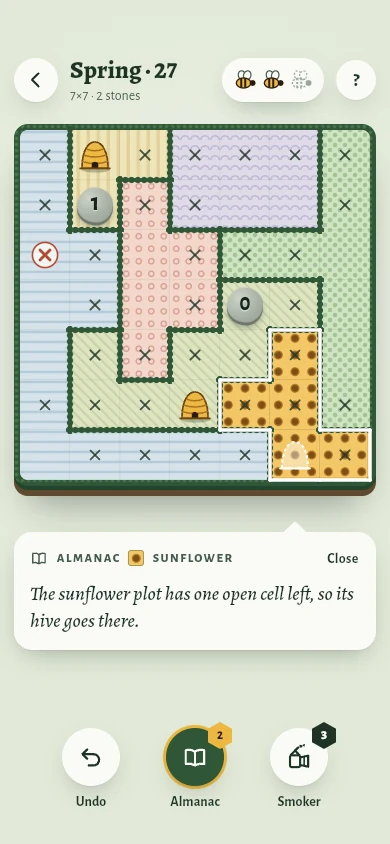 A 7×7 Spring field: crop plots with hedgerow borders, two straw hives, crossed-out cells, stones showing 1 and 0, and the Almanac explaining the next step.