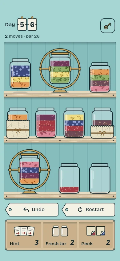 Three shelves of jars, two in brass cradles, two wrapped in wax paper