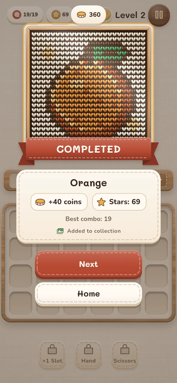 Level complete: the knitted orange is finished, earning 40 coins and joining the picture collection